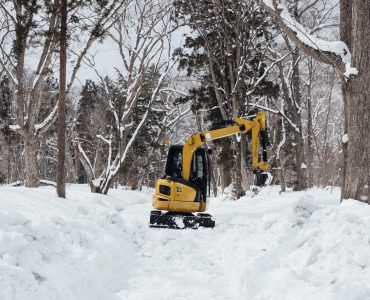 backhoe in snow at togakushi shrine, Japan